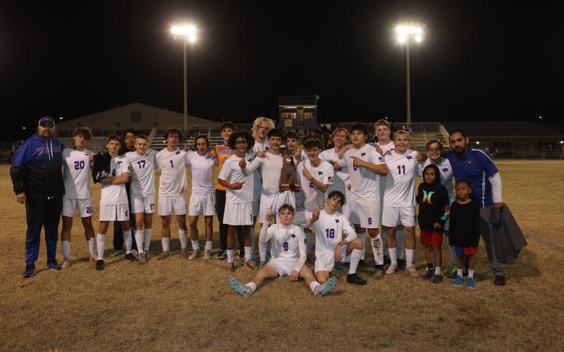 The Branford boys soccer team celebrates with the District 2-2A trophy after defeating Bell 3-2 on Thursday. (PAUL BUCHANAN/Lake City Reporter)
