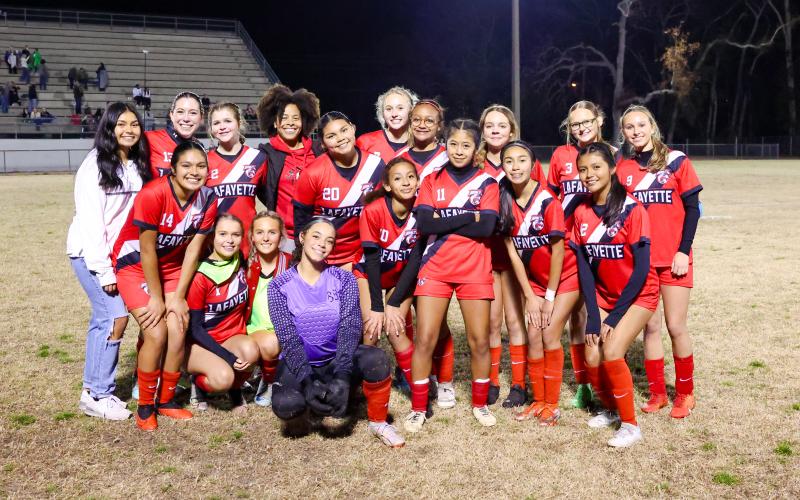 The Lafayette girls soccer team poses with the District 2-2A championship trophy after defeating Branford 1-0 on Tuesday night. (JACK HOWDESHELL/Lake City Reporter)