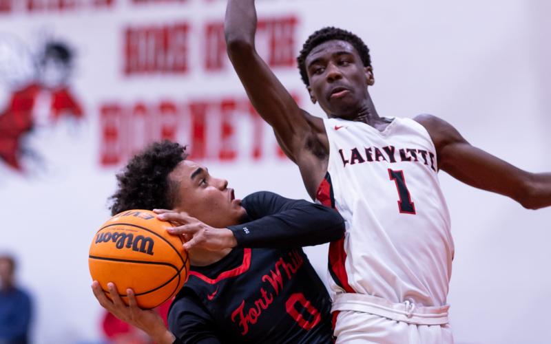 Fort White guard Tafari Moe tries to get off a shot while defended by Lafayette guard Jordan Murphy on Dec. 5. (JACK HOWDESHELL/Lake City Reporter)