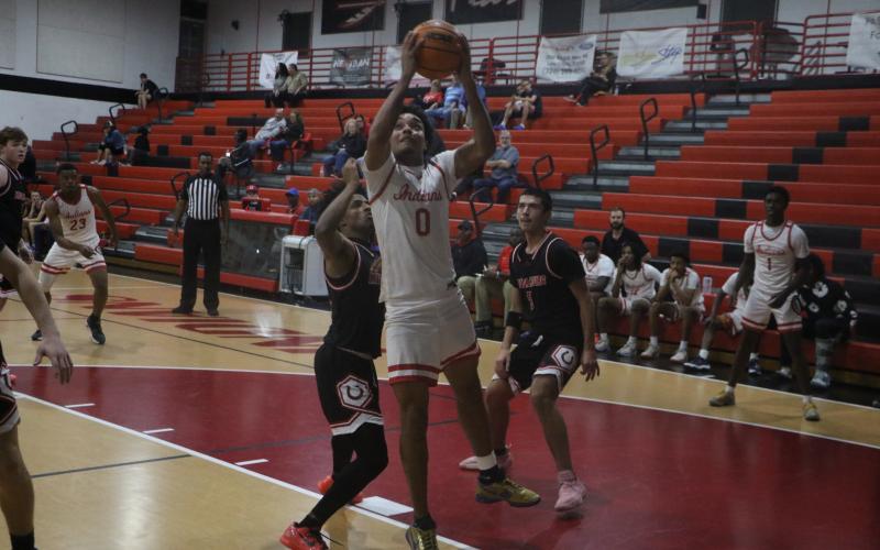 Fort White guard Tafari Moe goes for a layup during Monday's win against Middleburg. (MORGAN MCMULLEN/Lake City Reporter)