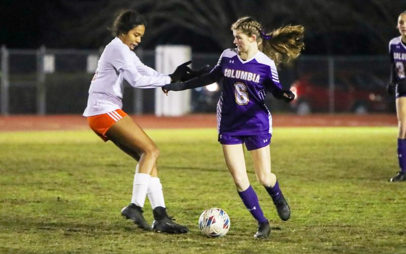 Columbia's Niki Sossie tries to maintain possession while defended by Orange Park's Ryanne Robinson on Thursday night. (BRENT KUYKENDALL/Lake City Reporter)