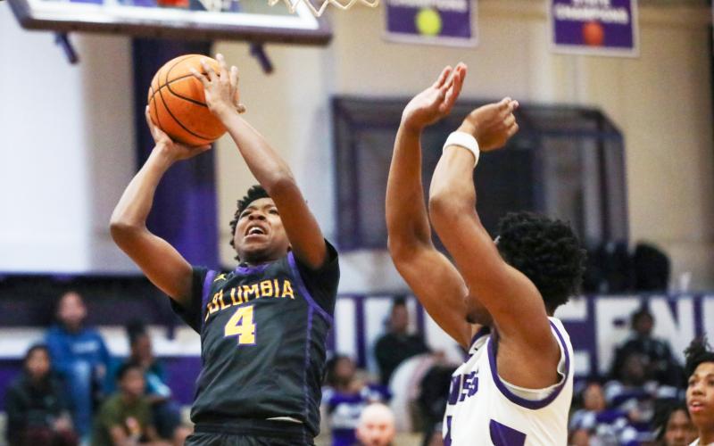 Columbia guard Shaheed White shoots while defended by Gainesville forward Cornelius White on Jan. 23. (BRENT KUYKENDALL/Lake City Reporter)