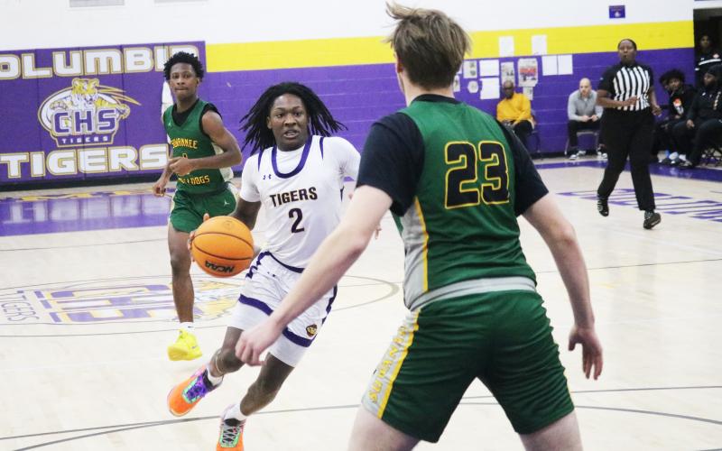 Columbia guard Kadrian Wilson pushes the ball up the floor in transition during Saturday's win over Suwannee. (JORDAN KROEGER/Lake City Reporter)