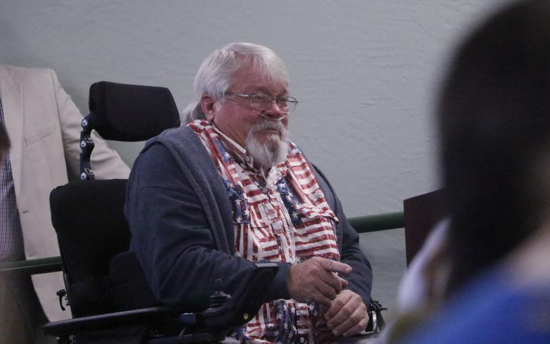Jeff Woods, a disabled veteran, pleads through tears with Sen. Jennifer Bradley and Rep. Chuck Brannan to provide help with the misuse of handicapped parking spaces. (JAMIE WACHTER/Lake City Reporter)