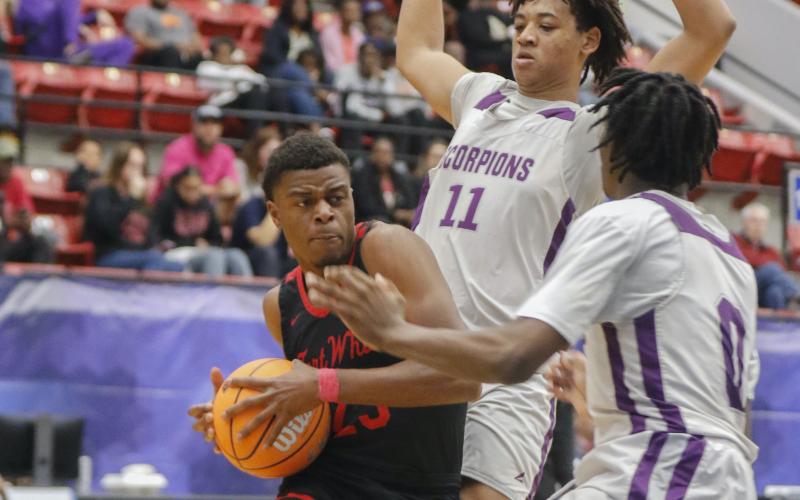 Fort White guard Kendal Henry gets double teamed by Crossroad Academy forward Trenton Jones (11) and guard Jabari Boahen (0) during the Class Rural state semifinals on Wednesday in Lakeland. (CALVIN KNIGHT/Special to the Reporter)