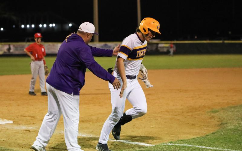 Columbia's Ayden Phillips is congratulated by coach Chris Howard after hitting a home run last season. (FILE)