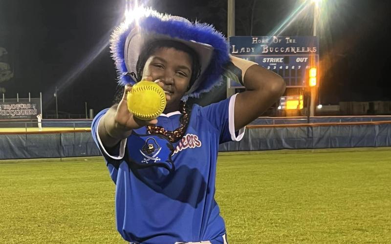 Branford's Mallory Blue shows off her grand slam ball after the Buccaneers defeated Middleburg on Tuesday night. (COURTESY)
