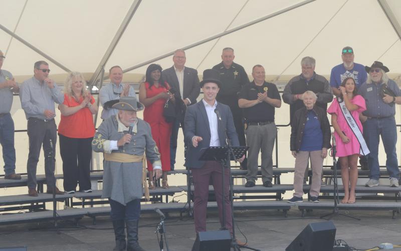 Lake City Mayor Noah Walker (right) gives a speech next to Tony Buzzella to open the 46th annual Olustee Festival. (TONY BRITT/Lake City Reporter)