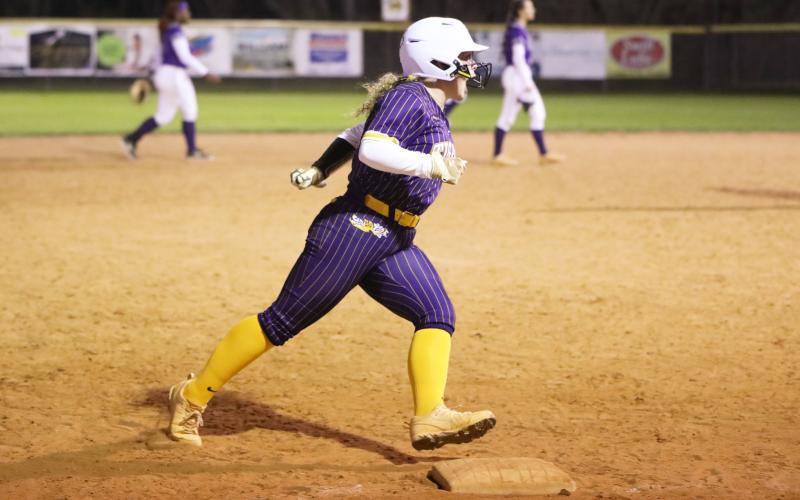 Columbia third baseman Alex Collins celebrates rounding third base after hitting a walk-off home run against Gainesville in extra innings on Feb. 18. (BRENT KUYKENDALL/Lake City Reporter)