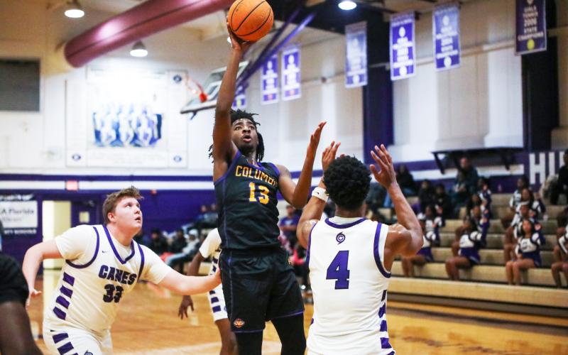 Columbia forward Zavian Douglas shoots over Gainesville forward Cornelius White on Jan. 23. (BRENT KUYKENDALL/Lake City Reporter)