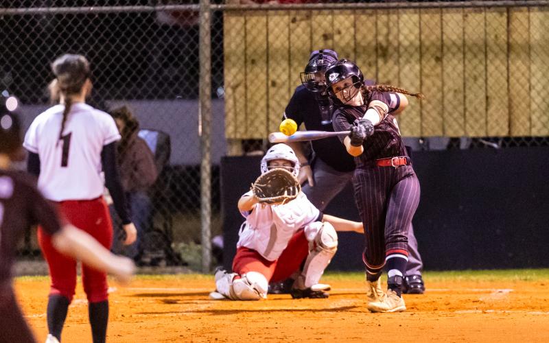 Fort White pitcher Hannah LeBleu knocks a base hit against Dixie County on Thursday. (JACK HOWDESHELL/Lake City Reporter)
