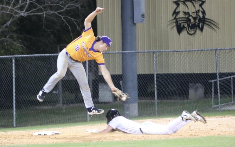 Buchholz shortstop Hudson Sapp slides safely into third base under the tag of Columbia third baseman Ayden Phillips on Friday night. (JORDAN KROEGER/Lake City Reporter)
