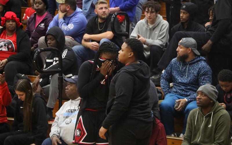 Fort White coach Bregay Harris hugs guard Zuri Hollie after Hollie fouled out in overtime of the Indians’ 67-64 loss to Hilliard in the Region 3-R championship. (MORGAN MCMULLEN/Lake City Reporter)