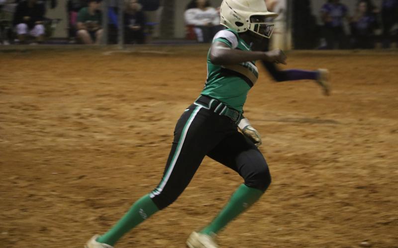 Suwannee center fielder Brianna Stephens rounds first base after hitting an RBI single in Tuesday's 5-2 win over Gainesville. (MORGAN MCMULLEN/Lake City Reporter)