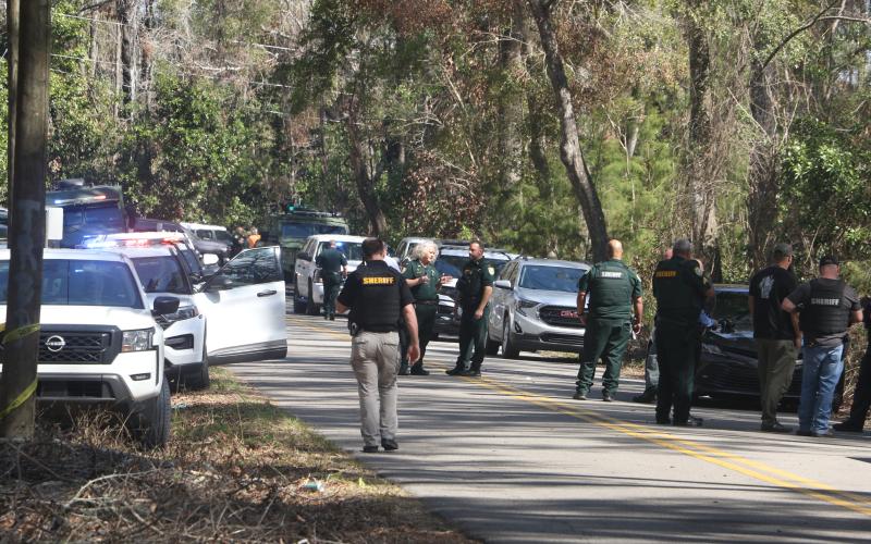 Columbia County Sheriff’s Office deputies arrive at the scene on SW Washington Avenue in Fort White in response to an officer-involved shooting Wednesday morning. (MORGAN MCMULLEN/Lake City Reporter)