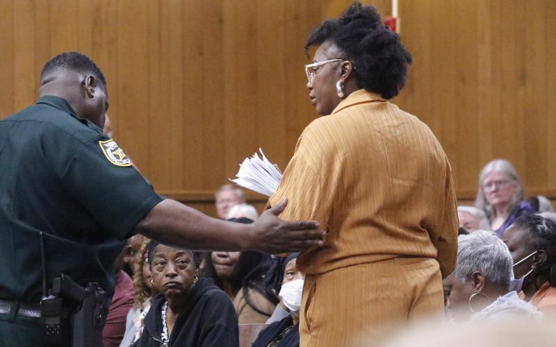 White Springs Town Manager Vanessa George is escorted out of the Hamilton County Courthouse courtoom Monday during the county’s legislative delegation hearing. George was removed after repeatedly interrupting Sen. Corey Simon. (JAMIE WACHTER/Lake City Reporter)