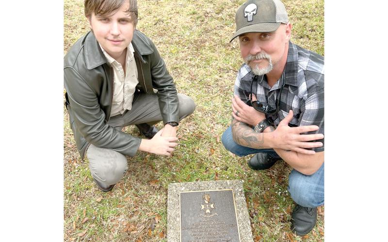 Todd Denmark (right) and his son, Jackson, visit their ancestor’s grave in St. Augustine as part of a trip to connect with their family’s history. (COURTESY)