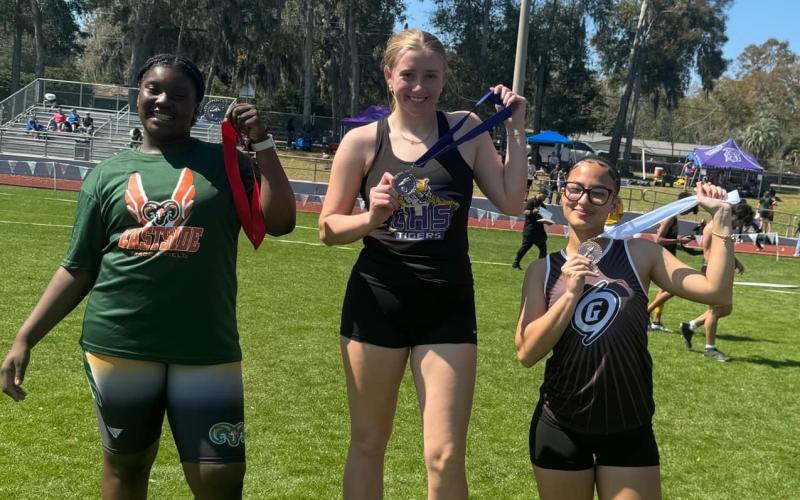 Columbia's Kyndall Norris shows off her first-place medal after winning the javelin at the SFHS Raiders Invitational on Saturday. (COURTESY)
