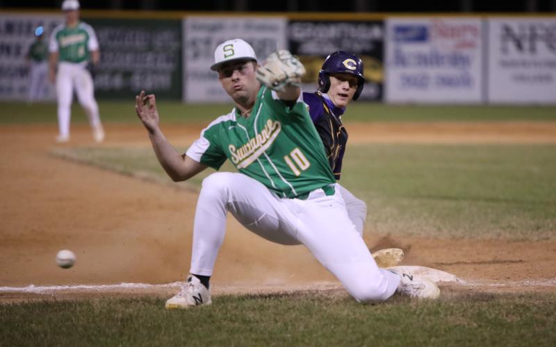 A throw gets past Suwannee third baseman Koy Frier, allowing Columbia shortstop Logan Brooks to score the go-ahead run in the fifth inning Tuesday night. (BRENT KUYKENDALL/Lake City Reporter)