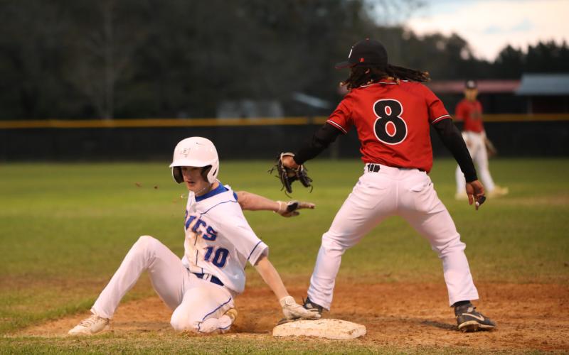 Branford's Patrick Williams slides safely into third base against Fort White on March 10. (BRENT KUYKENDALL/Lake City Reporter)