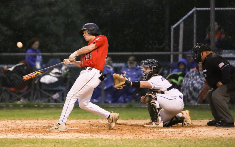 Fort White's Teagan Bell makes contact with a pitch against Branford on March 10. (BRENT KUYKENDALL/Lake City Reporter)