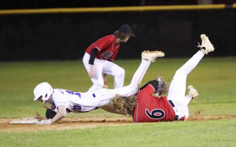 Branford shortstop Patrick Williams collides with Fort White shortstop Matthew Pitts as he tries to dive into second base Monday night. Pitts was called for obstruction and Williams was awarded an extra base. (BRENT KUYKENDALL/Lake City Reporter)