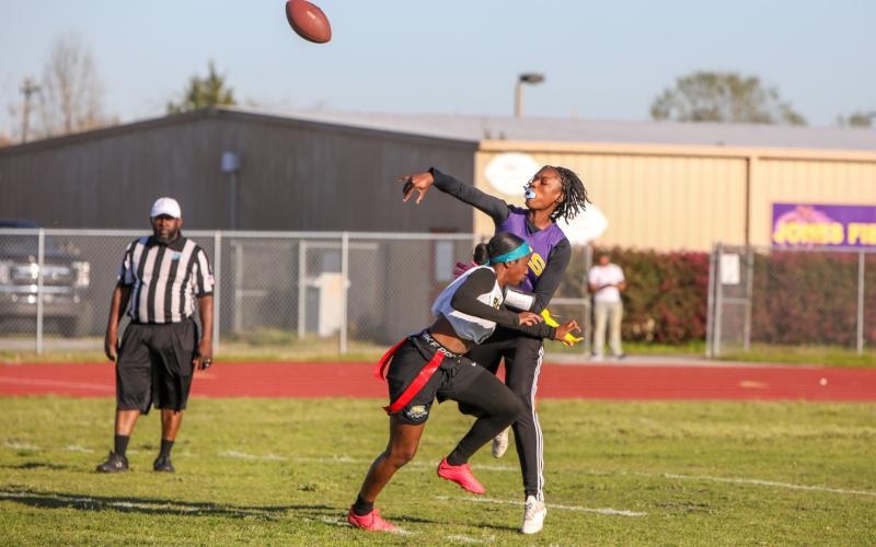 Columbia quarterback Eriel Baker throws a pass under pressure from a Buchholz defender on Tuesday night. (BRENT KUYKENDALL/Lake City Reporter)