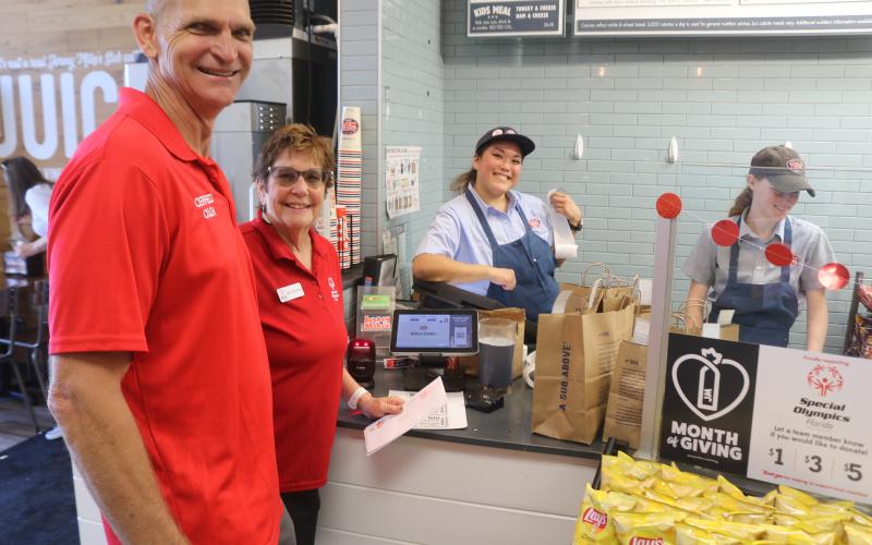 Jeff Wegner (from left), Lake City Christian Academy Special Olympics coach, and Marcia McAdams, a Columbia County Special Olympics representative, are served by Hannah Lagon, the district manager of the Lake City, Tallahassee and Valdosta, Ga., Jersey Mike’s restaurants, during the restaurant’s Giving Day on Wednesday. (TONY BRITT/Lake City Reporter)