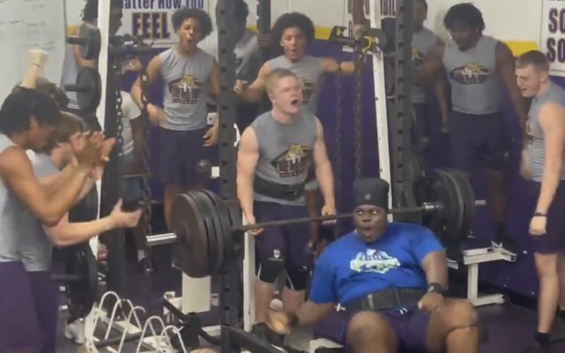 Columbia’s Chase Johnson celebrates with teammates after setting a personal record in the bench press during Wednesday’s meet against Hawthorne. (COURTESY)