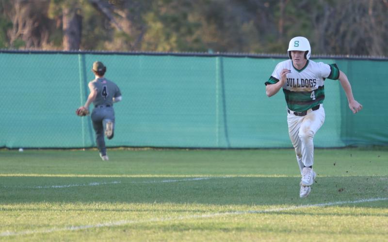 Suwannee first baseman Kyler Watson races home to score a run against Chiles on March 11. (PAUL BUCHANAN/Lake City Reporter)