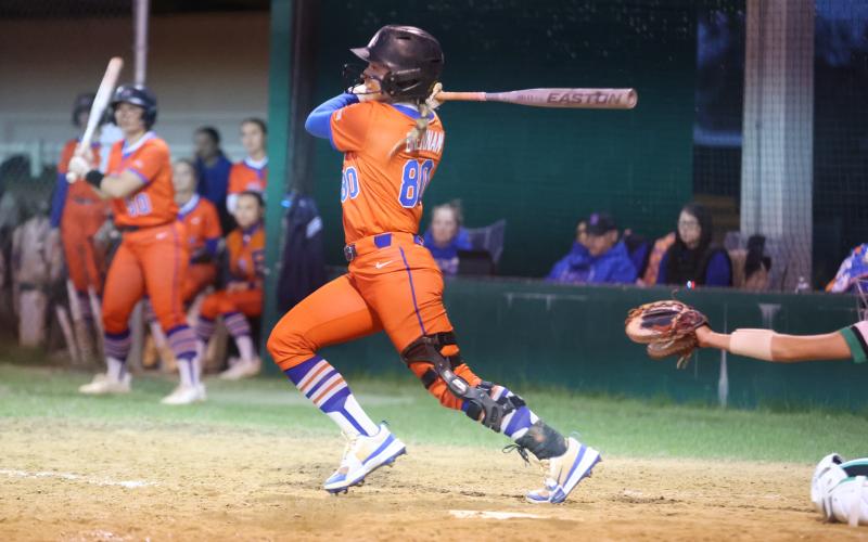 Branford catcher Morgan Brennan hits a single against Suwannee on Friday. (PAUL BUCHANAN/Lake City Reporter)