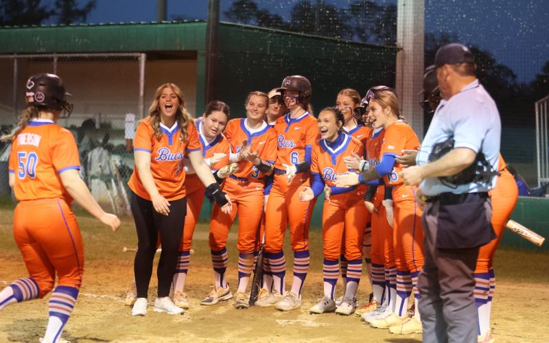 Branford's softball team greets Ellie Frierson at home plate after Frierson hit a home run against Suwannee on Friday night. (PAUL BUCHANAN/Lake City Reporter)