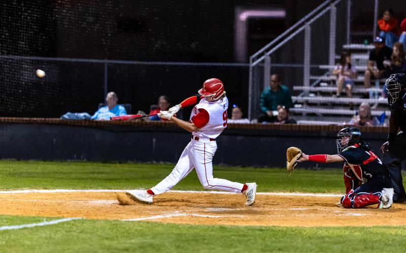 Lafayette third baseman Garrett Taylor hits a double against Fort White on Tuesday night. (JACK HOWDESHELL/Lake City Reporter)