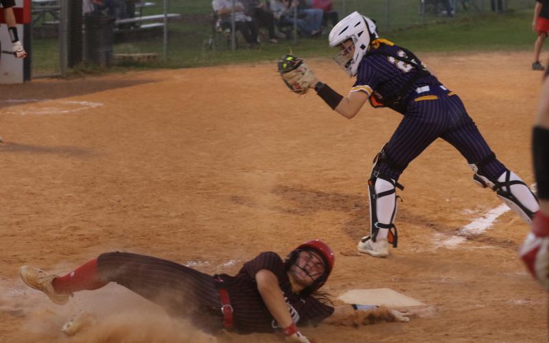 Williston’s Brooklyn Bertrand slides safely into home plate ahead of the tag from Columbia catcher Emily Delgado in the Tigers’ 11-0 loss Tuesday. (MORGAN MCMULLEN/Lake City Reporter)