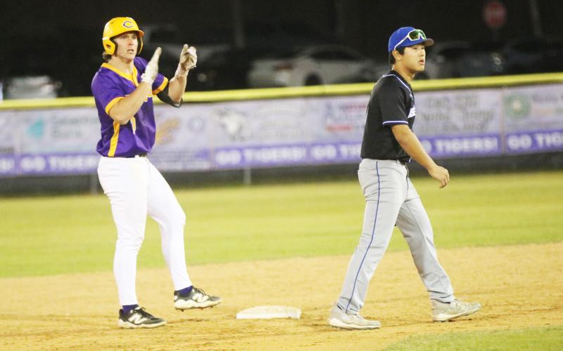 Columbia pitcher Ayden Phillips claps at second base after his two-RBI base hit against IMC Academy Gray on Friday night. (JORDAN KROEGER/Lake City Reporter)
