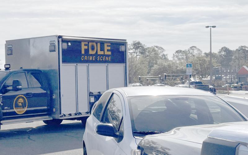 A Florida Department of Law Enforcement Crime Scene vehicle pulls out of the Home Depot parking lot Tuesday morning. FDLE helped process the scene of a 'suspicious' death in a vehicle at the Lake City store. (JAMIE WACHTER/Lake City Reporter)