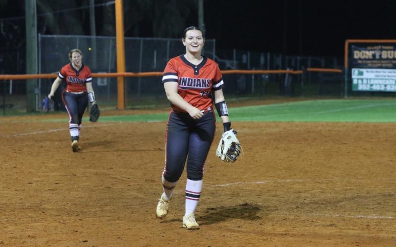 Fort White pitcher Kadence Compton is all smiles after striking out the final batter in Monday’s 7-5 win over Trenton as third baseman Hannah LeBleu cheers her on. (MORGAN MCMULLEN/Lake City Reporter)