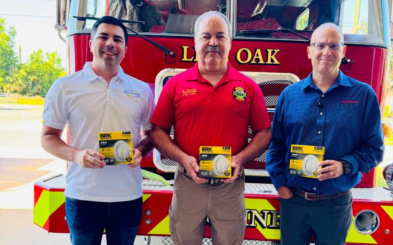 Live Oak Fire Chief Sidney Hayes (center) is pictured with Security Safe’s Joseph Peurrung (left) and Rob Cathcart with State Farm after the two companies donated 50 smoke detectors to the Live Oak Fire Department last week. (COURTESY)