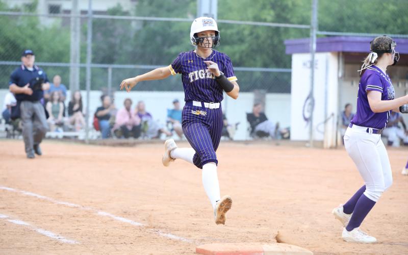 Columbia catcher Emily Delgado is thrown out at first base during Tuesday's loss to Gainesville. (BRENT KUYKENDALL/Lake City Reporter)