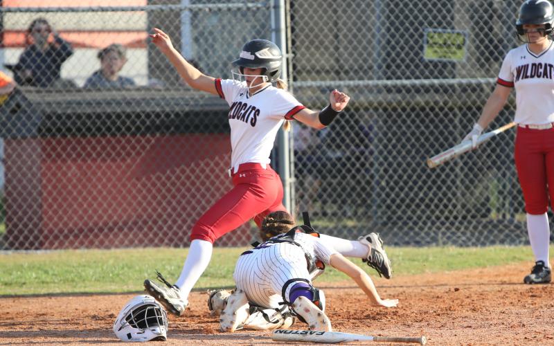 Columbia catcher Emily Delgado's tag isn't in time to stop one of Baker County's 10 runs on Thursday. (BRENT KUYKENDALL/Lake City Reporter)
