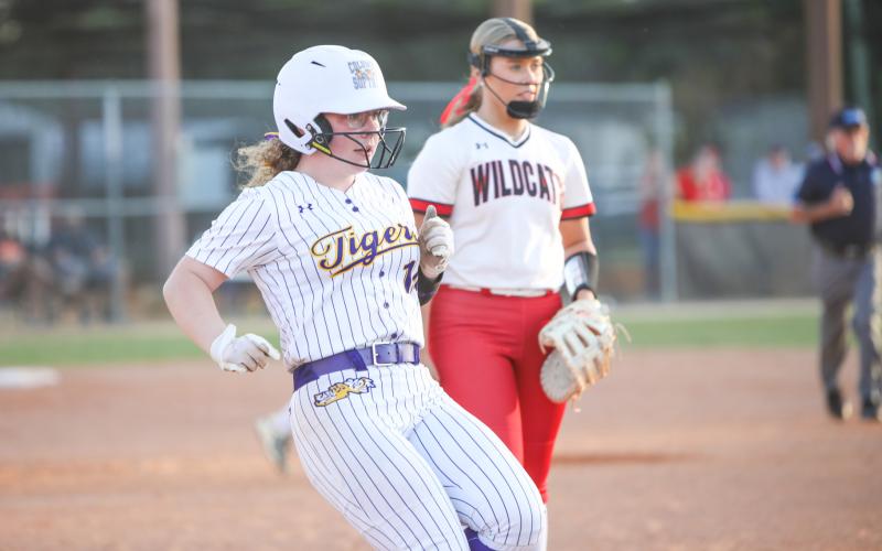Columbia third baseman Alex Collins reaches first base after hitting a single against Baker County on April 17. (BRENT KUYKENDALL/Lake City Reporter)