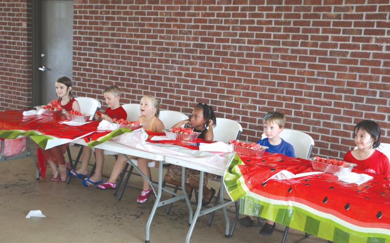 Quinny Shepple (from left), Cooper Shepple, Kahlani Kelley, Farrah Combs, Levi Powell and Ava Brown get ready to down some watermelon during the kids’ watermelon eating contest at the Rotary Club of Lake City’s downtown Independence Day event last year. (FILE)