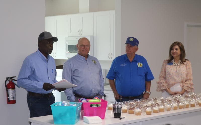 Fort White resident Marvin Brown (from left) details the history of the land on which the new Bethlehem Community Center sits during Tuesday’s ribbon cutting next to Columbia County Commissioners Rocky Ford and Everett Phillips as well as Lake City-Columbia County Chamber of Commerce Member Services Director Missy Hartley. (TONY BRITT/Lake City Reporter)