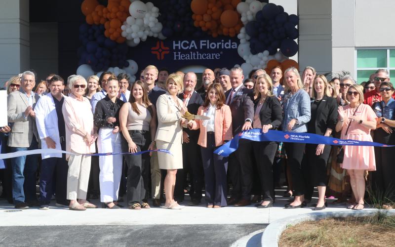 A crowd of well wishers, community supporters and local officials celebrate the ribbon cutting for the HCA Lake City Hospital’s expansion opening with board, administration and staff members on Tuesday. (TONY BRITT/Lake City Reporter)