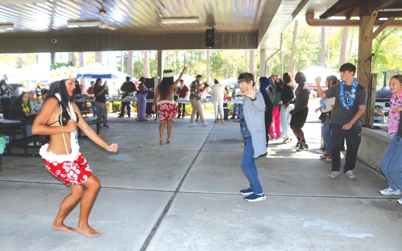 Members of Lana Kalias teach a group of Florida Gateway College students and faculty members how to properly do a Hula dance. (TONY BRITT/Lake City Reporter)