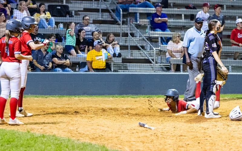 Santa Fe left fielder Madison Crosby slides safely into home plate to score a run against Columbia on Tuesday. (JACK HOWDESHELL/Lake City Reporter)