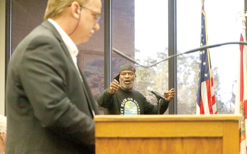 Darrell Bridgett points at Live Oak Development Manager George Curtis while questioning whether the city treats all developers equally during the Live Oak City Council meeting Tuesday. (JAMIE WACHTER/Lake City Reporter)