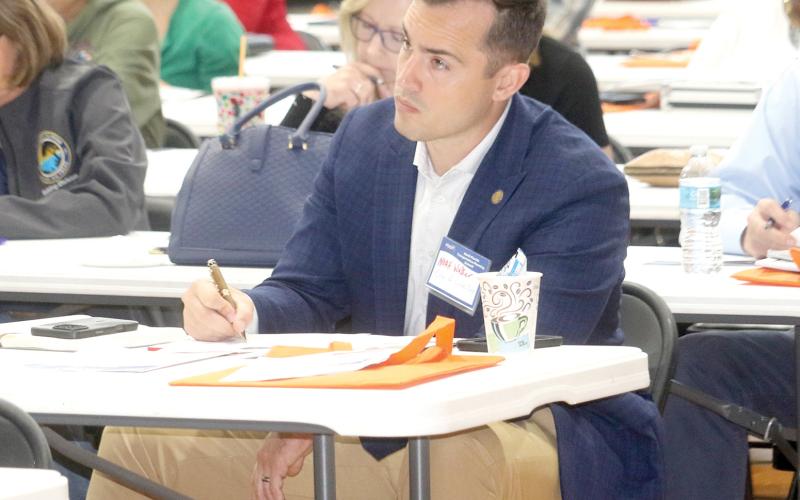 Lake City Mayor Noah Walker takes notes during one of the presentations at Tuesday’s North Florida Transportation Summit. (TONY BRITT/Lake City Reporter)