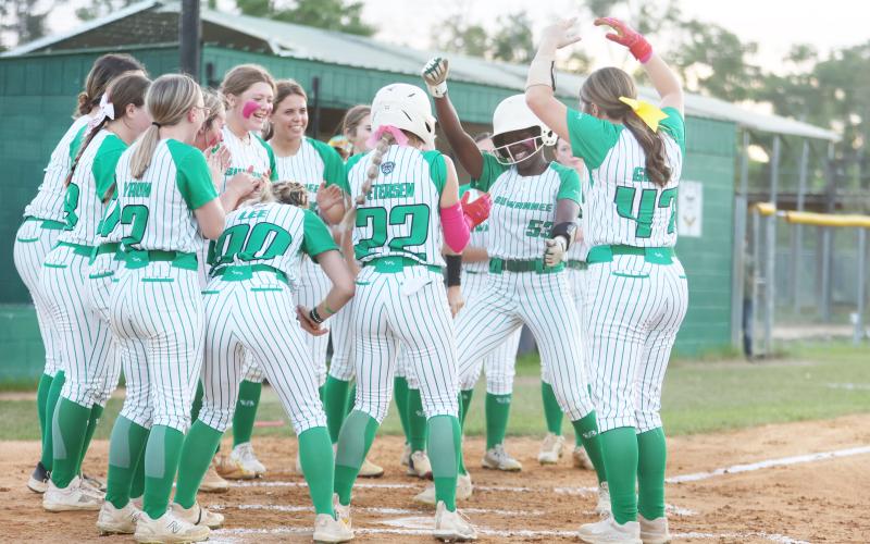 Suwannee outfielder Brianna Woods celebrates at home plate with her teammates after hitting a solo home run against Fort White on Friday. (PAUL BUCHANAN/Lake City Reporter)