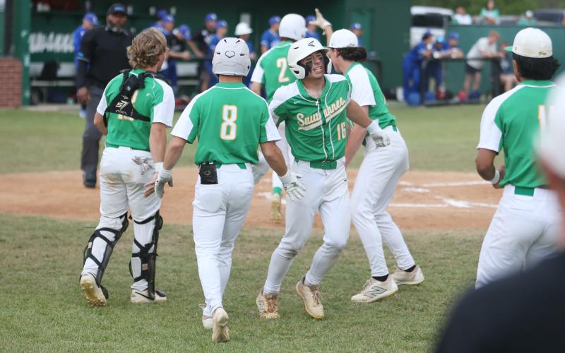 Suwannee's Hampton Newman (16) celebrates with teammates after scoring a run against Wolfson in the District 3-3A semifinals on Tuesday. (PAUL BUCHANAN/Lake City Reporter)